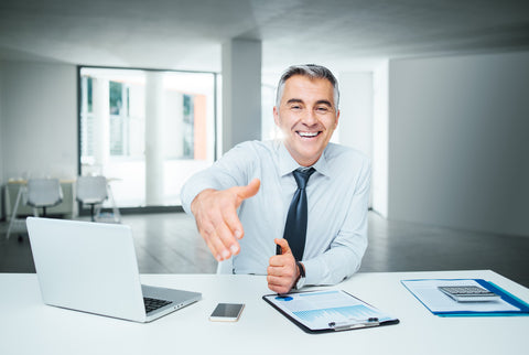 A virtual CFO sitting at a desk welcoming business owners.