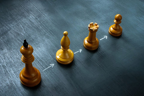 Chess pieces lined up representing business succession planning at Hall & Associates.